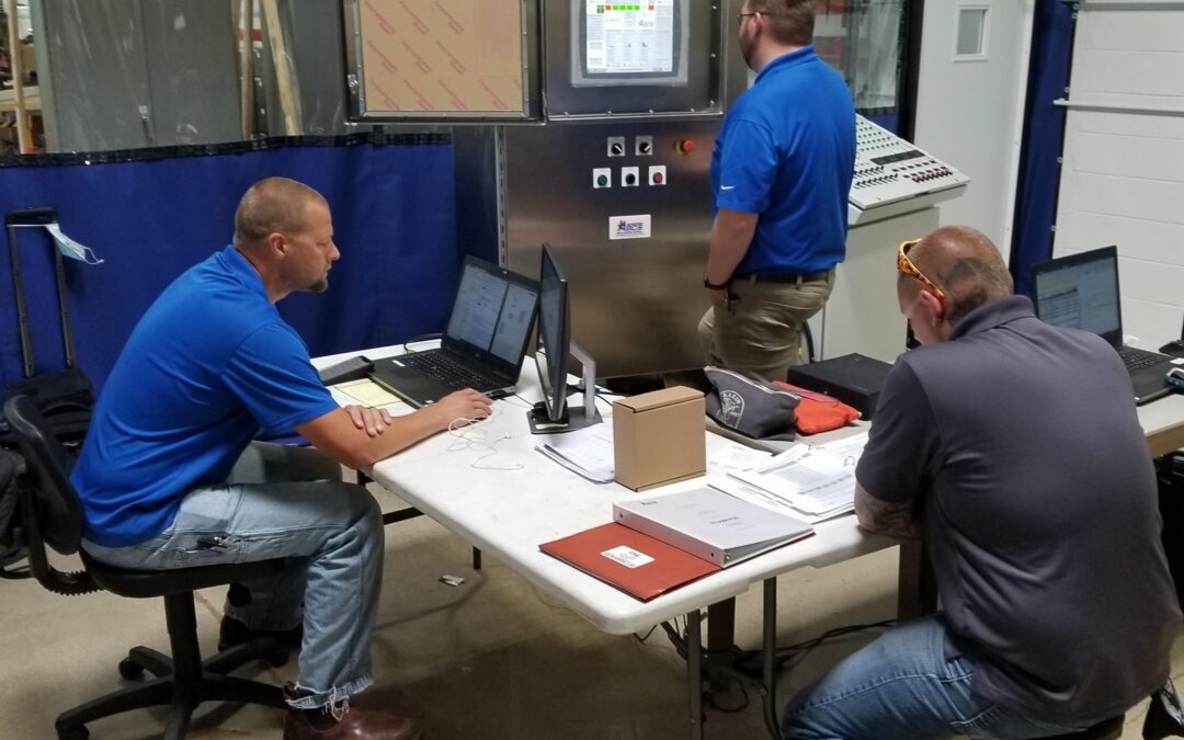 Several men performing a Factory Acceptance Test at Simplex